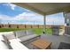 Inviting covered patio featuring a stainless steel grill, perfect for outdoor entertaining at 944 Alpine Ridge St, Erie, CO 80516