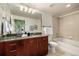 Bathroom featuring cherry vanity, granite counters, and tub/shower combination at 1700 Bassett St # 406, Denver, CO 80202