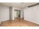 Bedroom with hardwood floors, a large mirrored closet, and concrete architectural details at 1700 Bassett St # 406, Denver, CO 80202