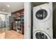 This kitchen features dark cabinetry, stainless steel appliances, and wood flooring at 1700 Bassett St # 406, Denver, CO 80202