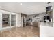 Modern kitchen with gray brick walls, stainless steel appliances, and wood flooring at 1700 Bassett St # 406, Denver, CO 80202