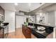 Modern kitchen with stainless steel appliances, granite counters, and hardwood floors provides open concept design at 1700 Bassett St # 406, Denver, CO 80202