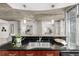Kitchen island with stainless steel sink, wooden cabinets, and bar seating overlooks the open-concept living spaces at 1700 Bassett St # 406, Denver, CO 80202