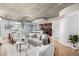 Cozy living room with modern decor, concrete ceiling, hardwood floors, and an open layout to the kitchen at 1700 Bassett St # 406, Denver, CO 80202