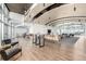 Spacious lounge area with chairs, a long table, and a TV at 1700 Bassett St # 406, Denver, CO 80202