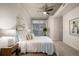 Cozy main bedroom featuring soft carpet, a ceiling fan, and ample natural light from the large window at 1700 Bassett St # 406, Denver, CO 80202
