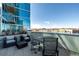 Relax on this patio featuring comfortable seating, outdoor dining, and stunning city views at 1700 Bassett St # 406, Denver, CO 80202