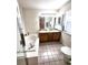 Bathroom with a double vanity, soaking tub, tiled floor, and updated fixtures at 3747 Windriver Trl, Castle Rock, CO 80109
