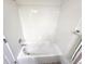Bright white tiled bathtub and shower combination with a chrome faucet at 3747 Windriver Trl, Castle Rock, CO 80109