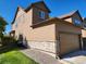 Charming home featuring brown siding, stone accents, an attached garage, and a well-maintained lawn at 3747 Windriver Trl, Castle Rock, CO 80109