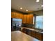 This kitchen features stainless appliances, oak cabinetry, and tiled flooring at 3747 Windriver Trl, Castle Rock, CO 80109