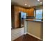 Spacious kitchen offers an island, stainless steel refrigerator and bright lighting at 3747 Windriver Trl, Castle Rock, CO 80109