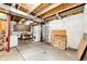 Unfinished basement with exposed beams, concrete floor, washer, dryer, and shelving at 5660 S Algonquian Way # C, Aurora, CO 80016