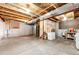 Unfinished basement featuring open ceiling, concrete floor, and exposed utilities at 5660 S Algonquian Way # C, Aurora, CO 80016