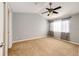 Spacious bedroom with neutral carpet, ceiling fan, natural light, and ample closet space at 5660 S Algonquian Way # C, Aurora, CO 80016