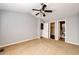 Bright bedroom with carpet, ceiling fan and featuring three closet doors and attached bathroom at 5660 S Algonquian Way # C, Aurora, CO 80016