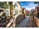 Charming townhome exterior featuring stone accents, wood siding, and a well-maintained walkway with landscaping at 5660 S Algonquian Way # C, Aurora, CO 80016