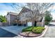 Townhome complex with attached garages, stone accents, and landscaped yards at 5660 S Algonquian Way # C, Aurora, CO 80016