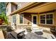 Inviting front porch area with decorative stone, neutral siding, and an entryway with a welcome mat at 5660 S Algonquian Way # C, Aurora, CO 80016