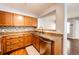 This kitchen features stainless steel appliances, granite countertops, wood cabinetry, and a view to the living space at 5660 S Algonquian Way # C, Aurora, CO 80016