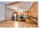Well lit kitchen features stainless steel appliances, wood cabinets, mosaic backsplash, and granite countertops at 5660 S Algonquian Way # C, Aurora, CO 80016