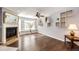 Bright living room showcasing hardwood floors, a fireplace with mantel, and an inviting open layout at 5660 S Algonquian Way # C, Aurora, CO 80016