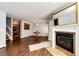 Open living area with hardwood floors, a fireplace, and seamless transition to the adjacent kitchen at 5660 S Algonquian Way # C, Aurora, CO 80016