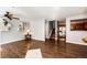 Open-concept living room with hardwood floors, modern shelving, and seamless flow to the kitchen at 5660 S Algonquian Way # C, Aurora, CO 80016