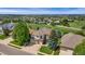Stunning aerial view of home on golf course with lush landscaping and mature trees at 6323 S Sicily Way, Aurora, CO 80016