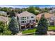 Aerial view of a home with a large backyard, multi-level deck, mature trees, and a well-manicured lawn at 6323 S Sicily Way, Aurora, CO 80016