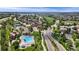 Aerial view of the home at 6323 S Sicily Way, nearby tennis courts, and community pool at 6323 S Sicily Way, Aurora, CO 80016