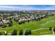 An aerial view of the home at 6323 S Sicily Way with a golf course in the backyard at 6323 S Sicily Way, Aurora, CO 80016