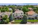 Aerial view of a home with an expansive backyard, multi-level deck, and a beautifully landscaped garden at 6323 S Sicily Way, Aurora, CO 80016