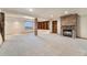 Finished basement with a stone fireplace, built-in shelving, and ample space for relaxation and entertainment at 6323 S Sicily Way, Aurora, CO 80016