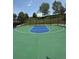 Outdoor basketball court with green and blue play area and chain link fence at 6323 S Sicily Way, Aurora, CO 80016