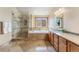 Elegant bathroom with a glass shower, soaking tub, and dual sink vanity at 6323 S Sicily Way, Aurora, CO 80016