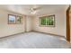 Bright bedroom with large windows providing ample natural light and soft carpeting at 6323 S Sicily Way, Aurora, CO 80016