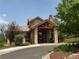 Exterior of community clubhouse with stone columns, wood beams, and tile roof at 6323 S Sicily Way, Aurora, CO 80016