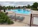 Community pool with slide, lounge chairs, and umbrellas at 6323 S Sicily Way, Aurora, CO 80016
