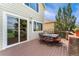 Outdoor deck featuring patio table with chairs and large sliding glass door at 6323 S Sicily Way, Aurora, CO 80016
