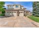 Beautiful two-story home featuring a three-car garage, brick accents, and manicured lawn at 6323 S Sicily Way, Aurora, CO 80016