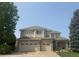 Exterior of the two-story home showcasing a three-car garage and brick accents at 6323 S Sicily Way, Aurora, CO 80016