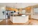 Spacious kitchen features a large island, stainless appliances, granite counters, and ample cabinet space at 6323 S Sicily Way, Aurora, CO 80016