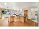 Bright kitchen featuring an island with cooktop, hardwood floors, and a breakfast bar at 6323 S Sicily Way, Aurora, CO 80016