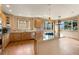Gourmet kitchen boasting hardwood floors, granite countertops, stainless appliances, and bright windows at 6323 S Sicily Way, Aurora, CO 80016
