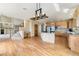Open-concept kitchen seamlessly connects to the living area with a desk and staircase at 6323 S Sicily Way, Aurora, CO 80016