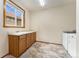 Functional laundry room with ample counter space, sink, and modern washer and dryer at 6323 S Sicily Way, Aurora, CO 80016
