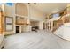 Bright and airy living room features a fireplace, custom built-ins, and staircase to the upper level at 6323 S Sicily Way, Aurora, CO 80016