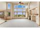 Bright living room with tall ceilings, large windows, and a cozy fireplace at 6323 S Sicily Way, Aurora, CO 80016