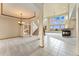Spacious living room with fireplace, large windows, and elegant staircase at 6323 S Sicily Way, Aurora, CO 80016